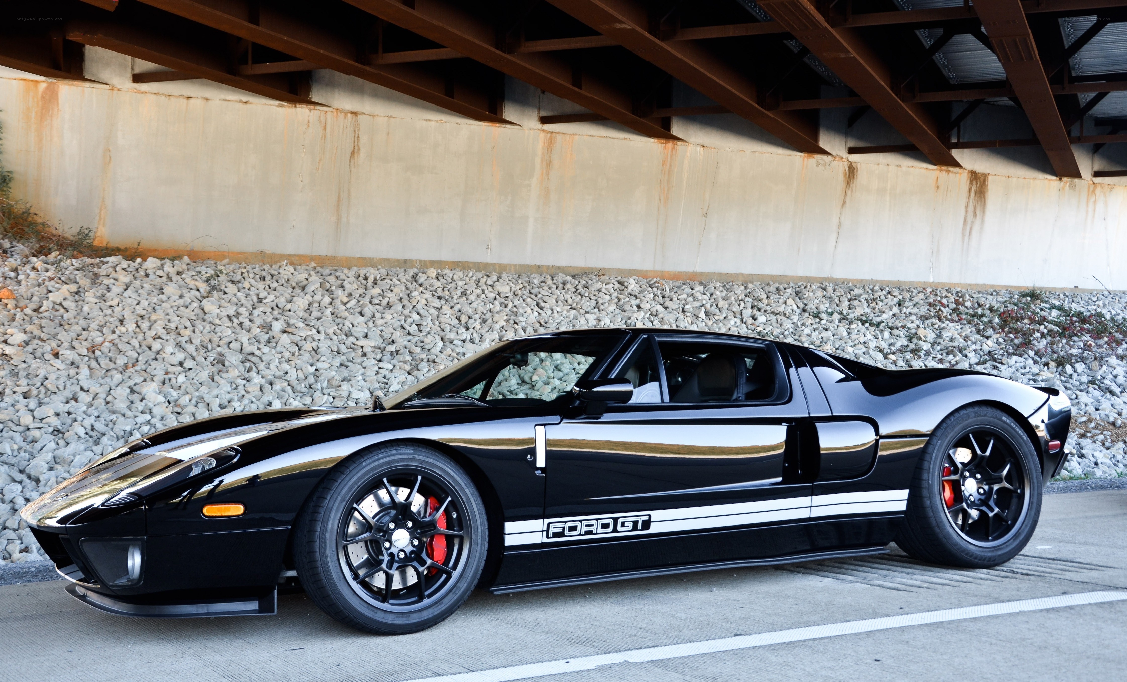 Black Ford GT under a bridge