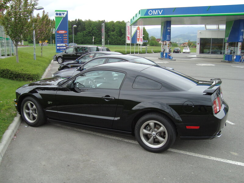 Black Ford Mustang at gas station