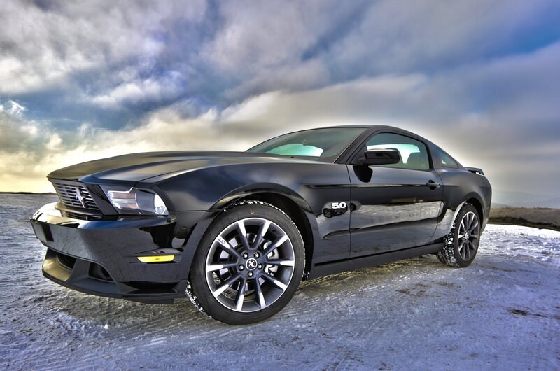 Black Ford Mustang in snowy landscape