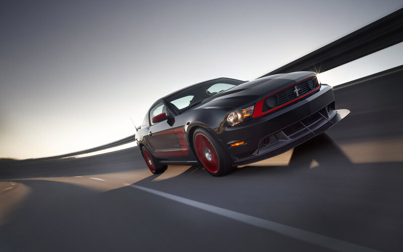 Black Ford Mustang on a highway