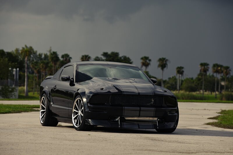 Black Ford Mustang on a road
