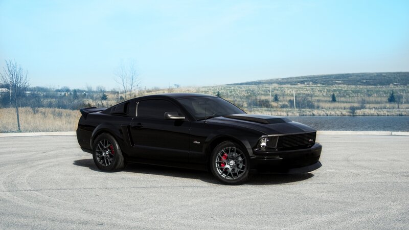 black ford mustang on asphalt