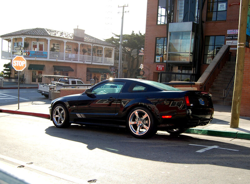 Black Ford Mustang on city street