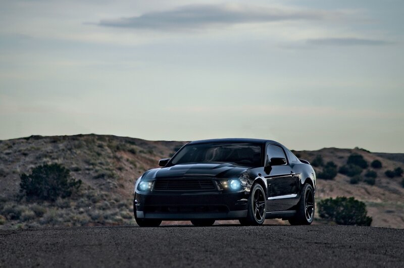 Black Ford Mustang on desert road
