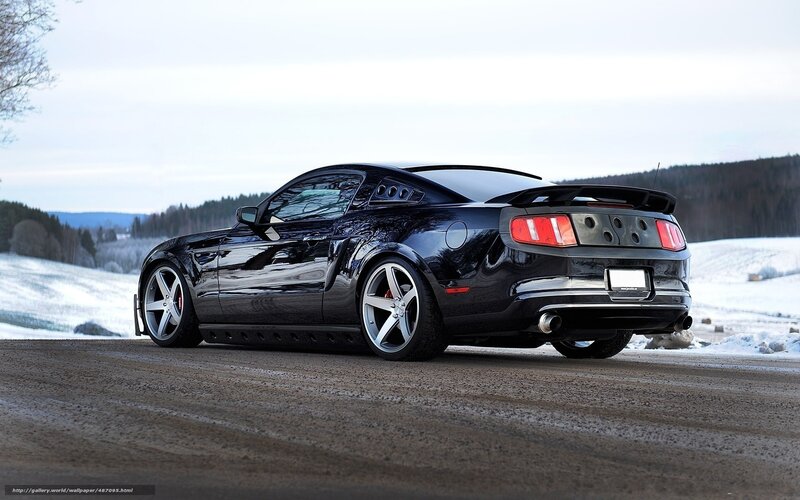 Black Ford Mustang on snowy road