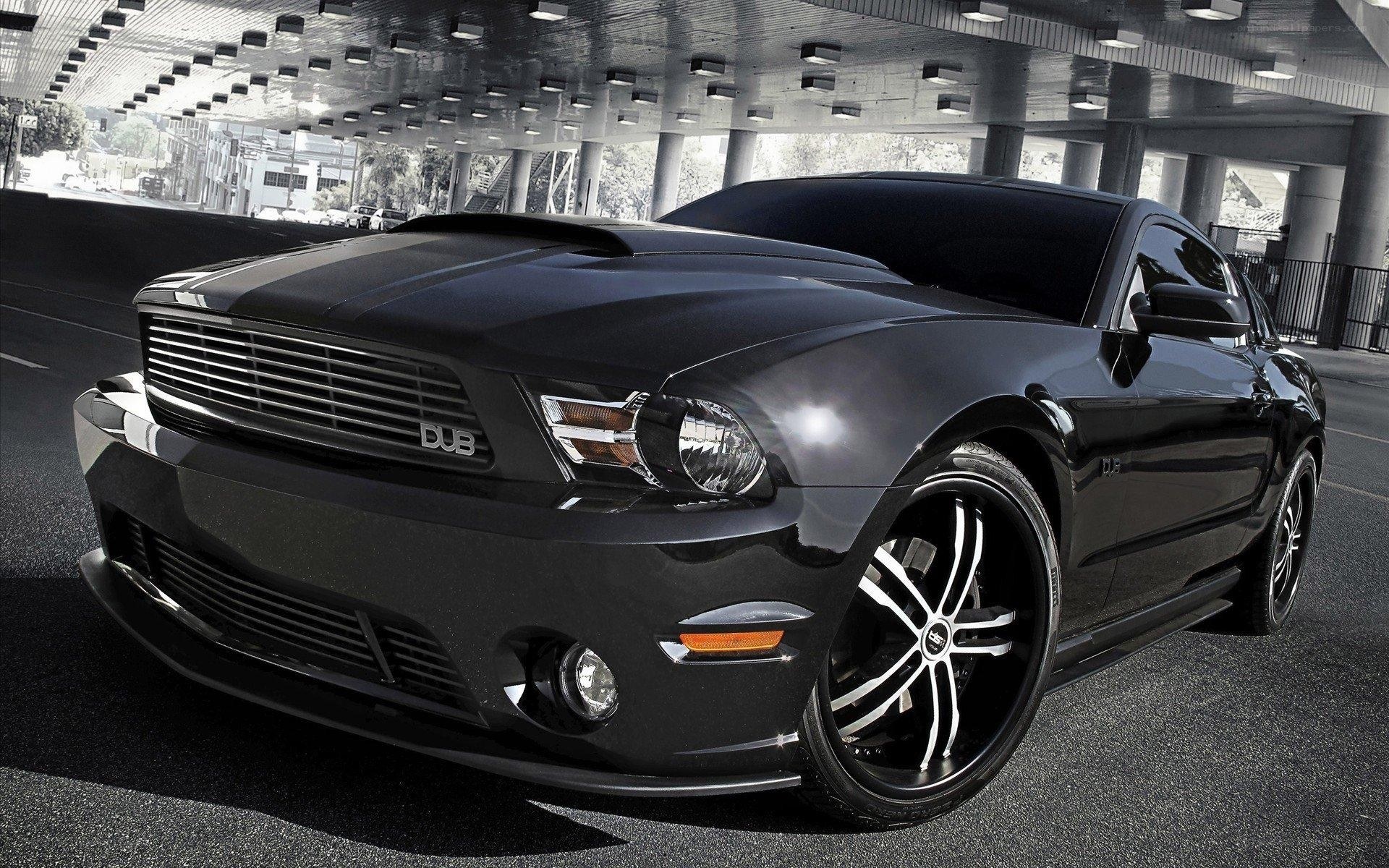 Black Ford Mustang under overpass