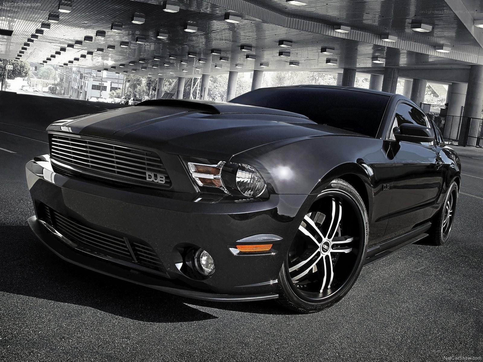 Black Ford Mustang with custom wheels