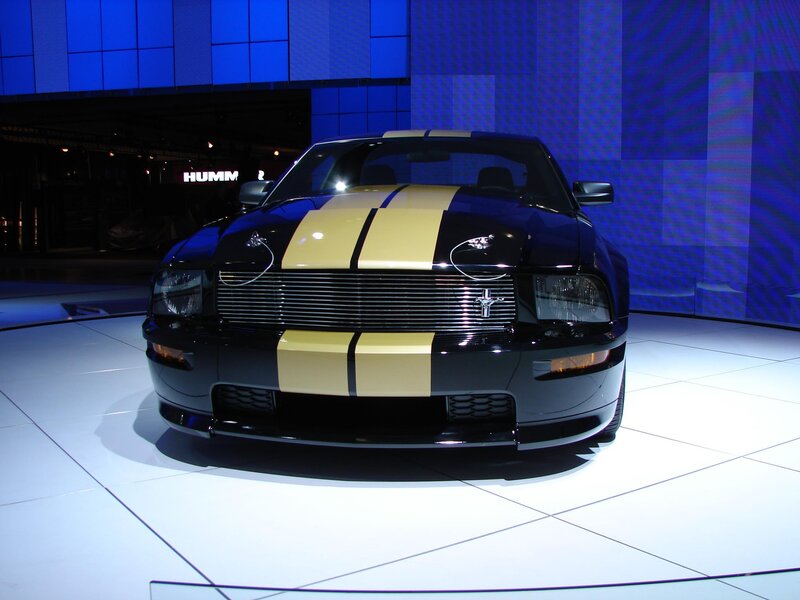 Black Ford Mustang with gold stripes