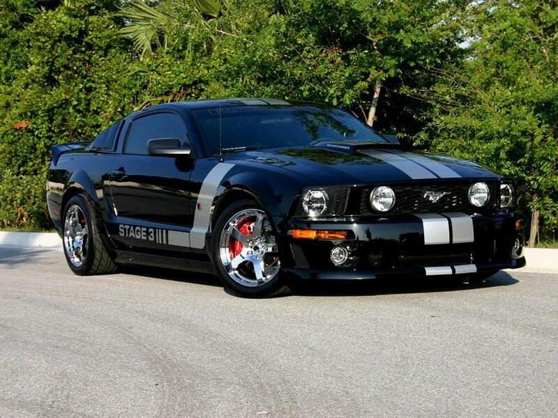 Black Ford Mustang with racing stripes