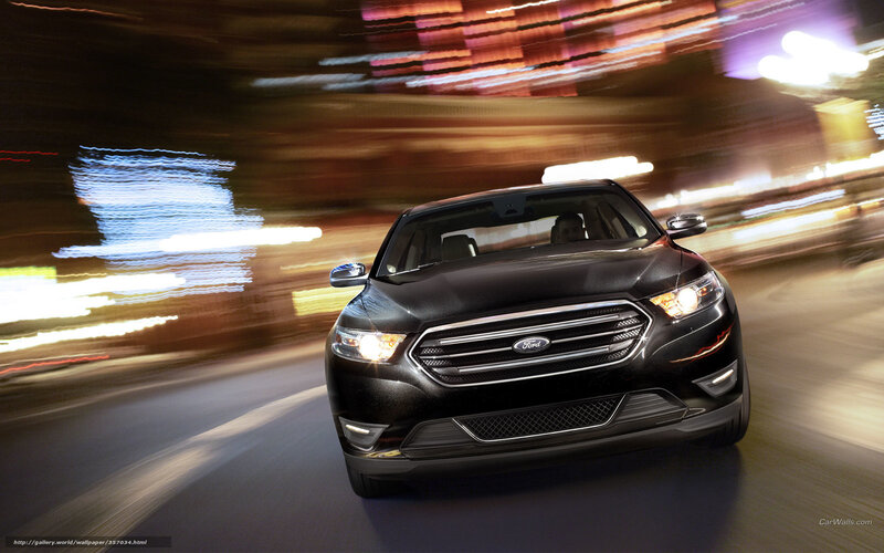 Black Ford Taurus at night
