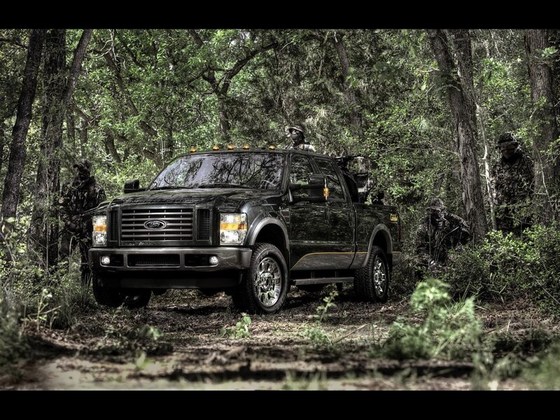 Black Ford truck in forest with soldiers