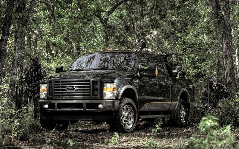 Black Ford truck in forest with soldiers