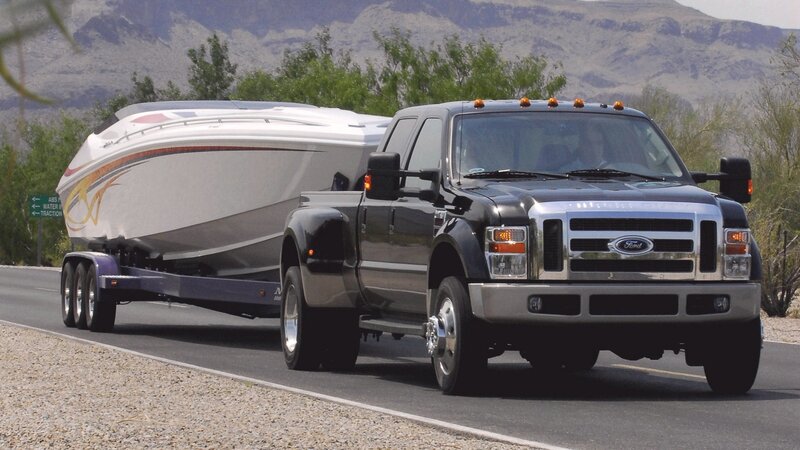 black ford truck towing boat