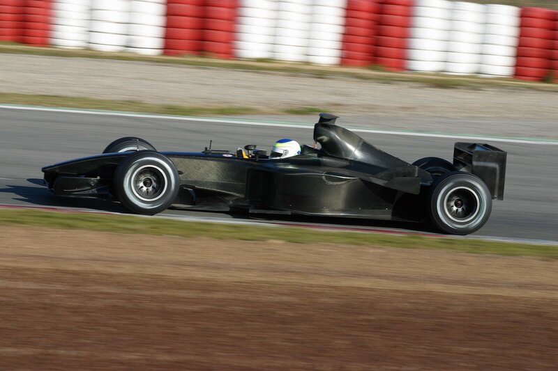 Black Formula One Car — Dynamic, Afternoon, Photograph, Driver, Racetrack