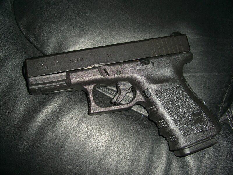 black glock pistol on leather