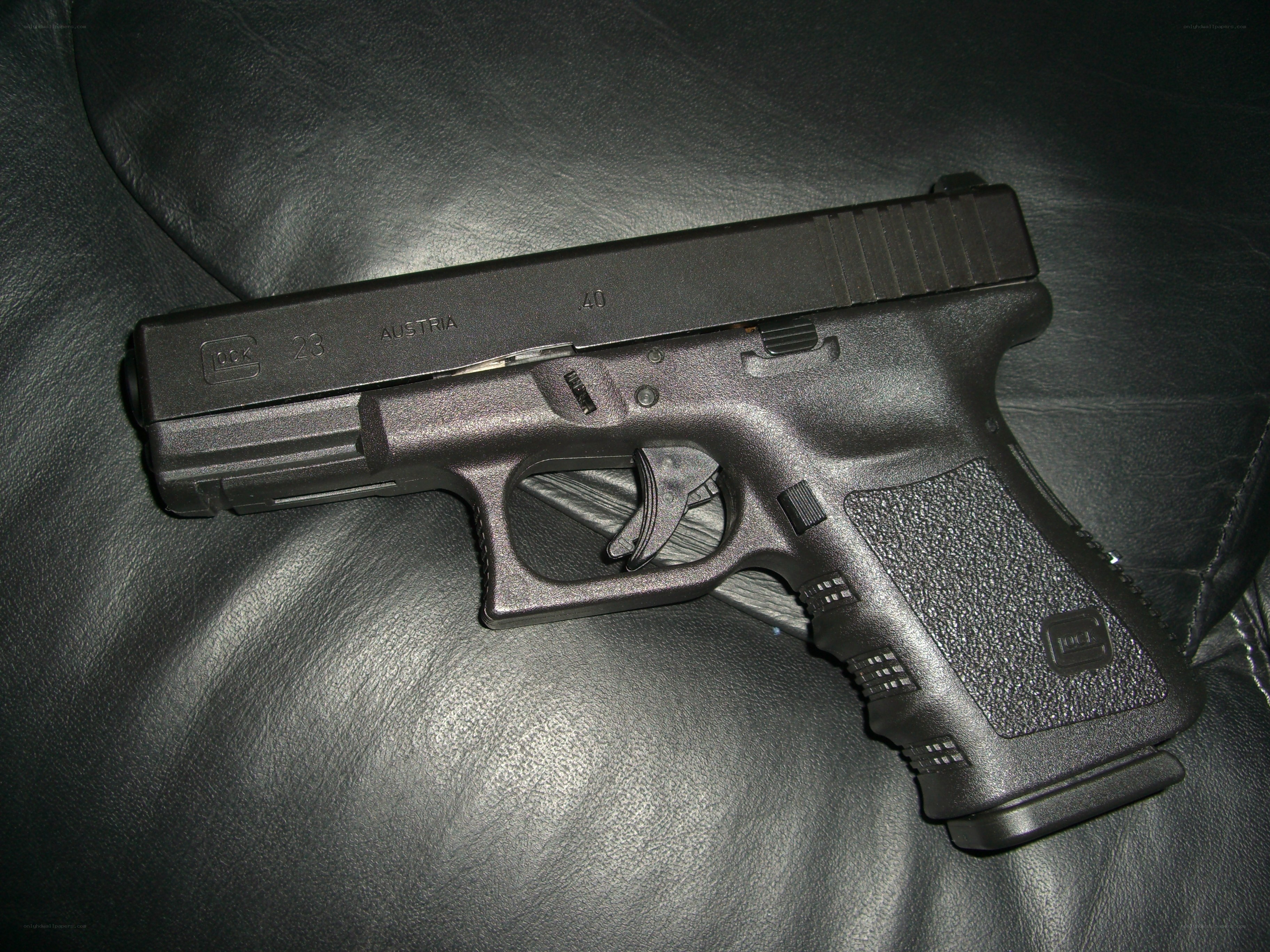 black glock pistol on leather
