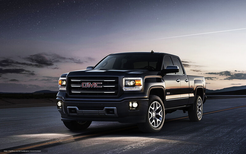 Black GMC pickup truck at night