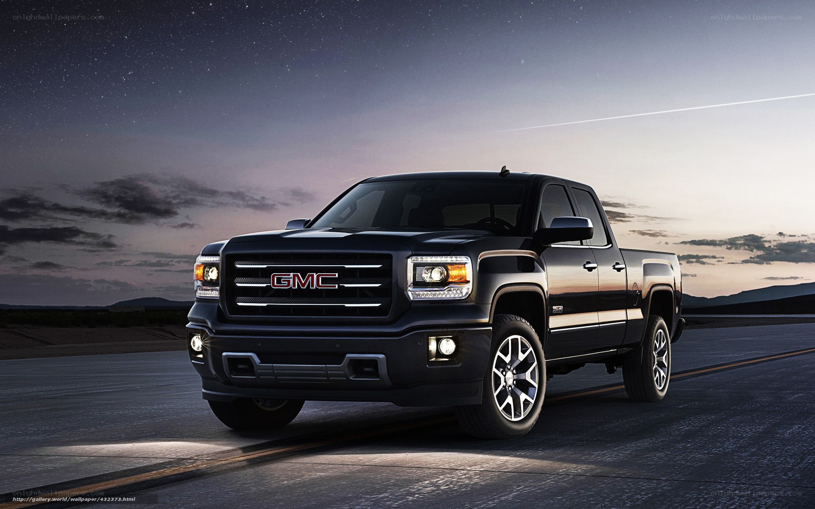 Black GMC pickup truck at night