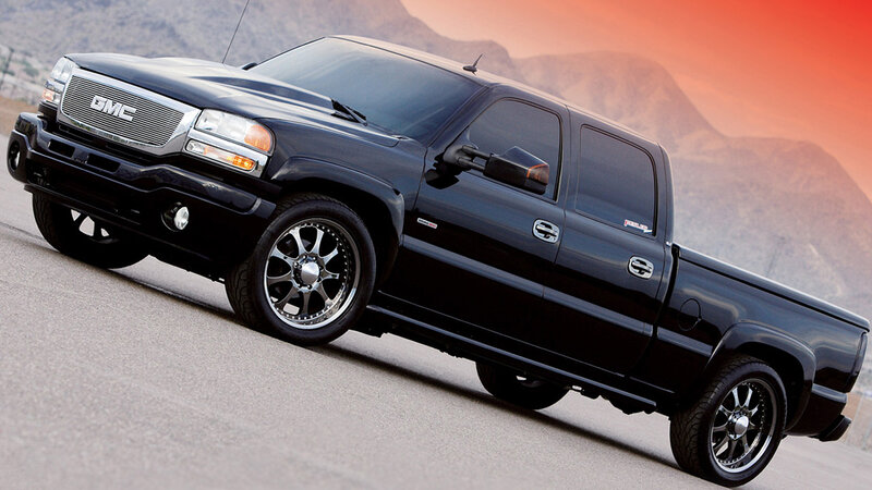 Black GMC pickup truck on road