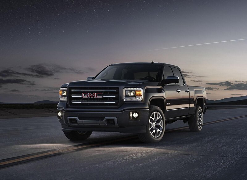Black GMC pickup truck on road