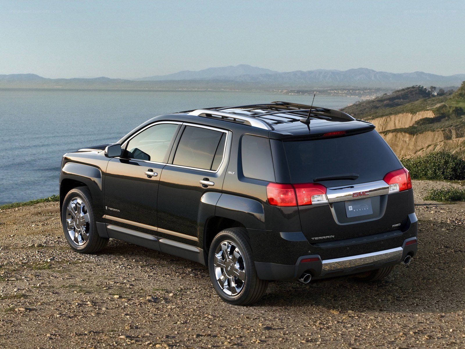 Black GMC Terrain on a cliffside