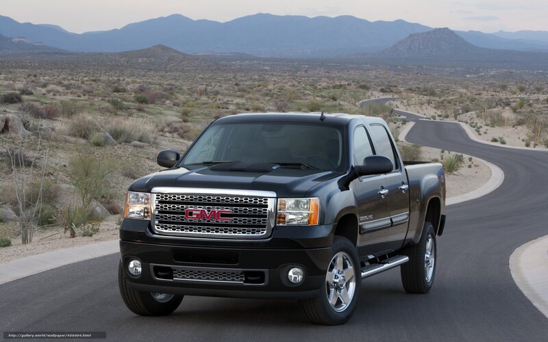 Black GMC truck on desert road