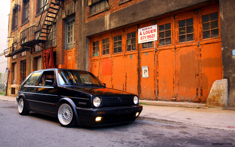 Black Golf parked in alley