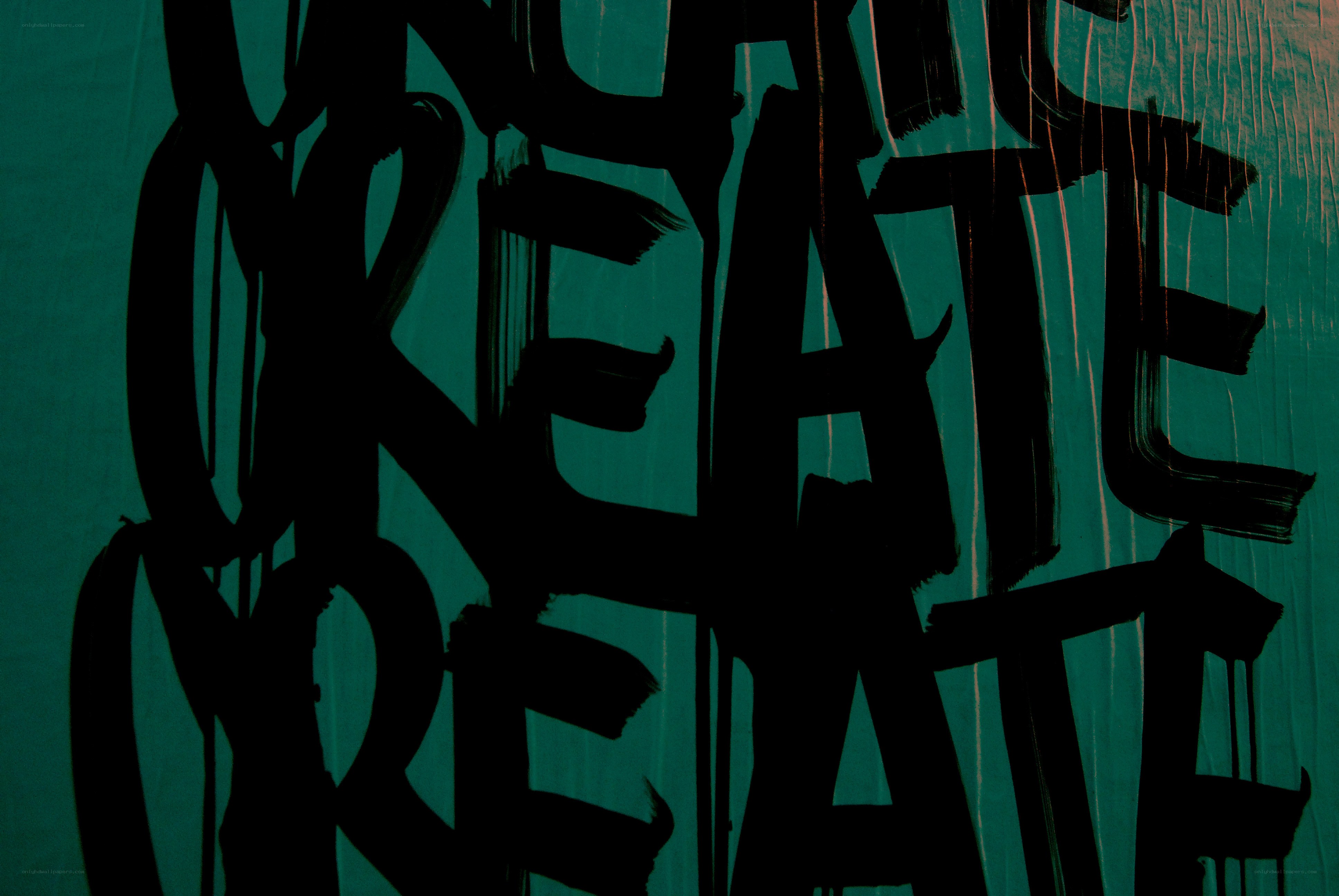 black graffiti on green wall
