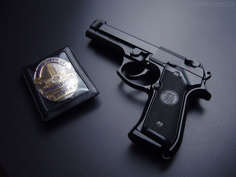 Black Handgun and Badge — Dramatic