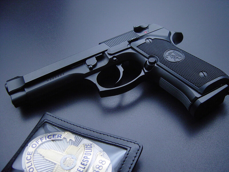 Black Handgun and Badge