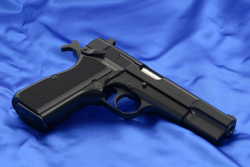 Black handgun on blue cloth
