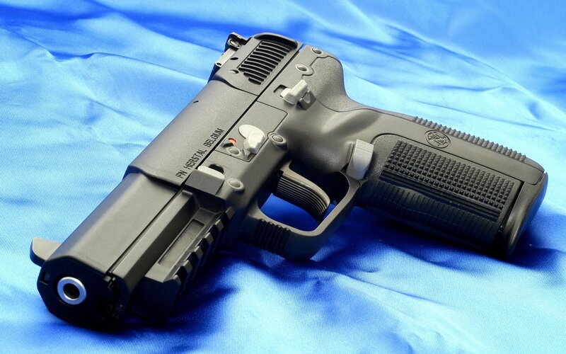black handgun on blue cloth