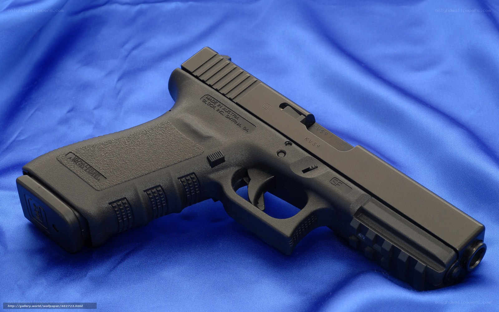 Black handgun on blue cloth
