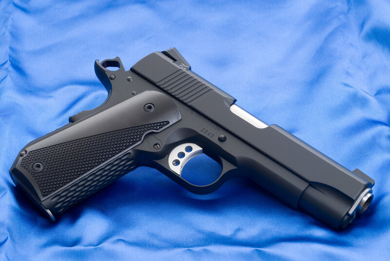 Black Handgun on Blue Cloth — Neutral