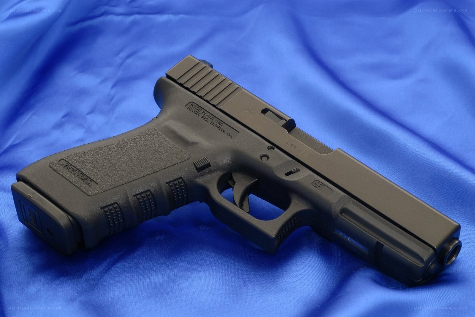 Black handgun on blue cloth