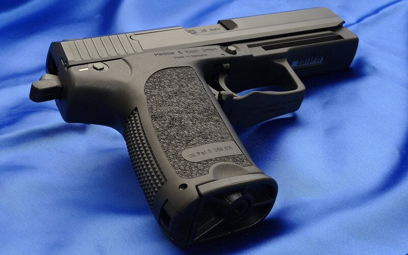 black handgun on blue fabric