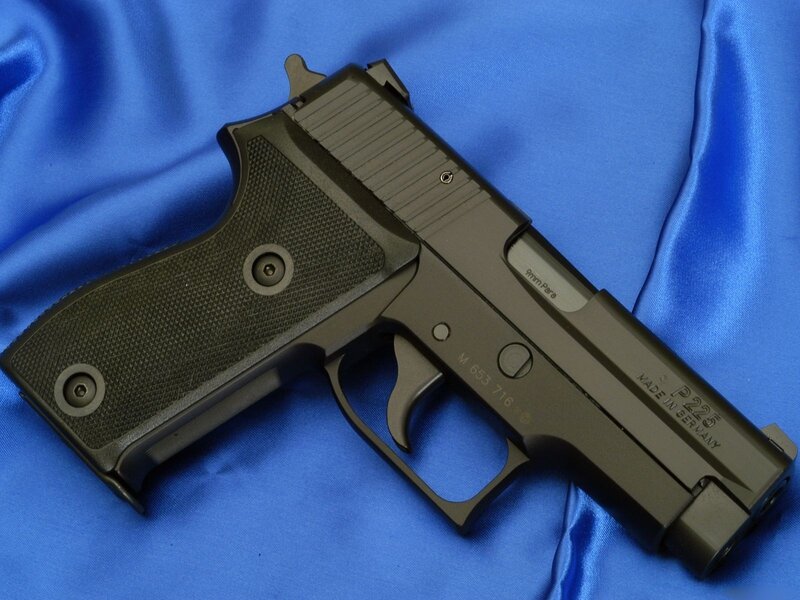 black handgun on blue fabric