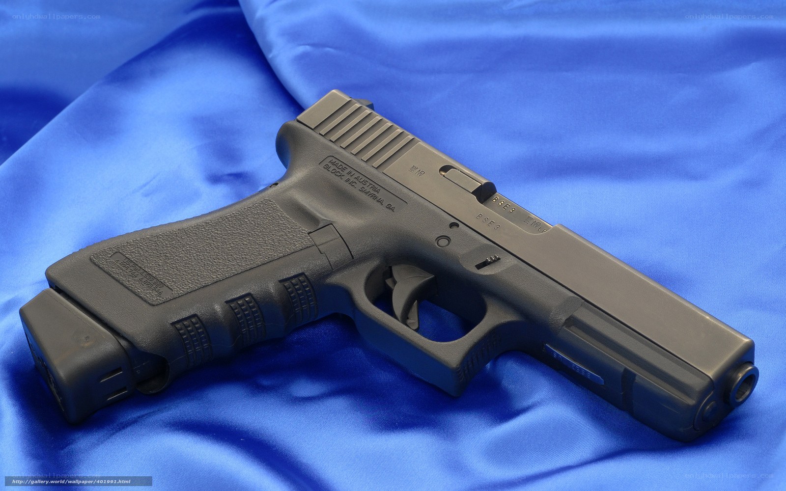 Black handgun on blue fabric