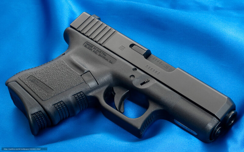 Black handgun on blue fabric