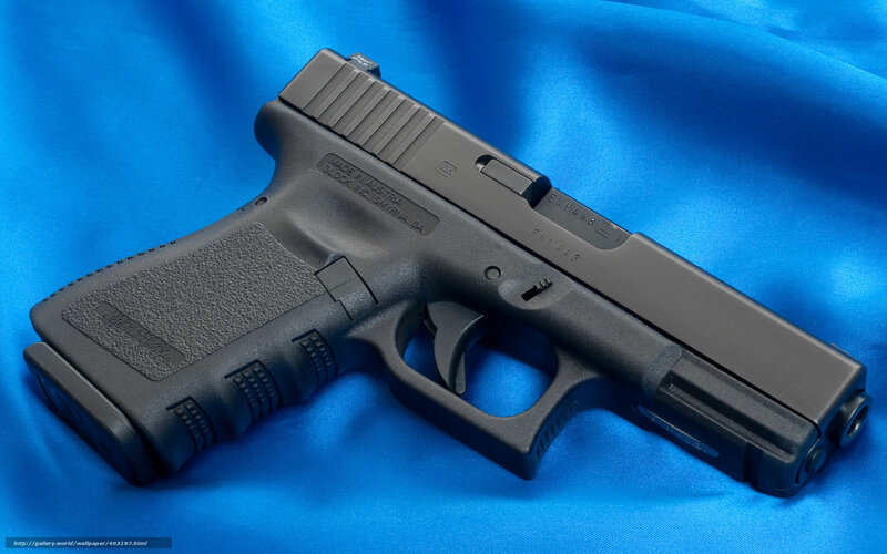 Black handgun on blue fabric
