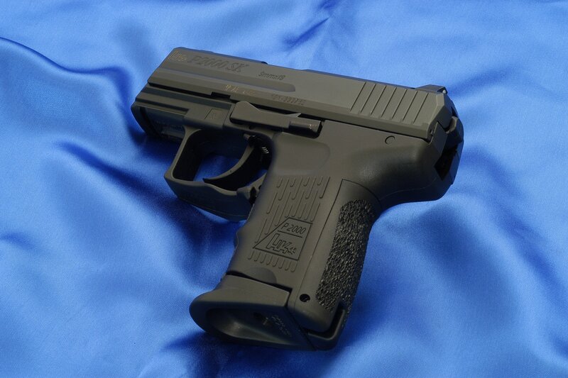 Black handgun on blue fabric
