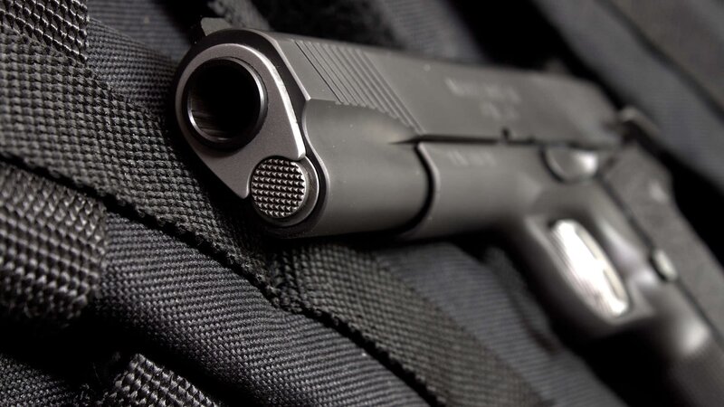 Black Handgun on Fabric — Dramatic