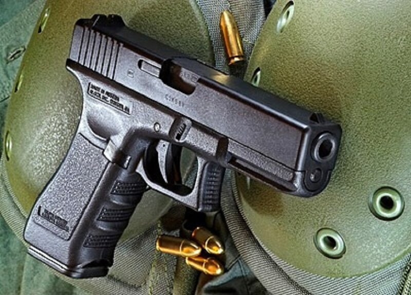 Black Handgun on Helmet