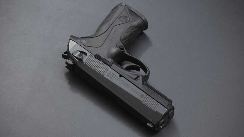 Black Handgun on Surface — Gray