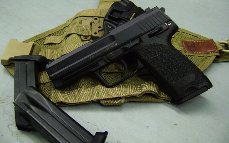 Black handgun on tactical gear