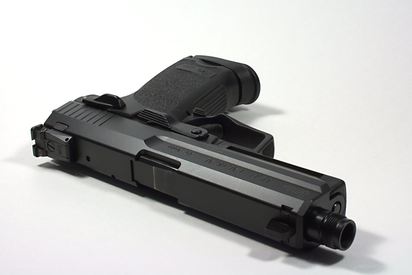 black handgun on white surface
