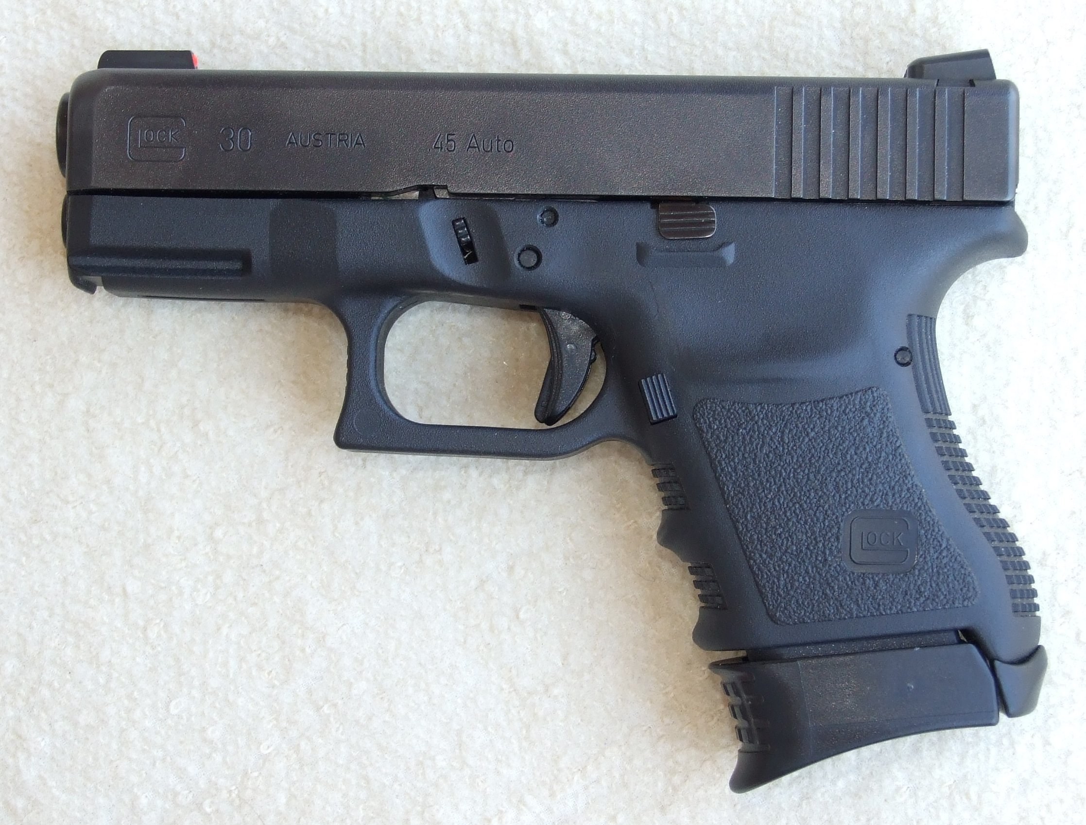 Black handgun on white surface
