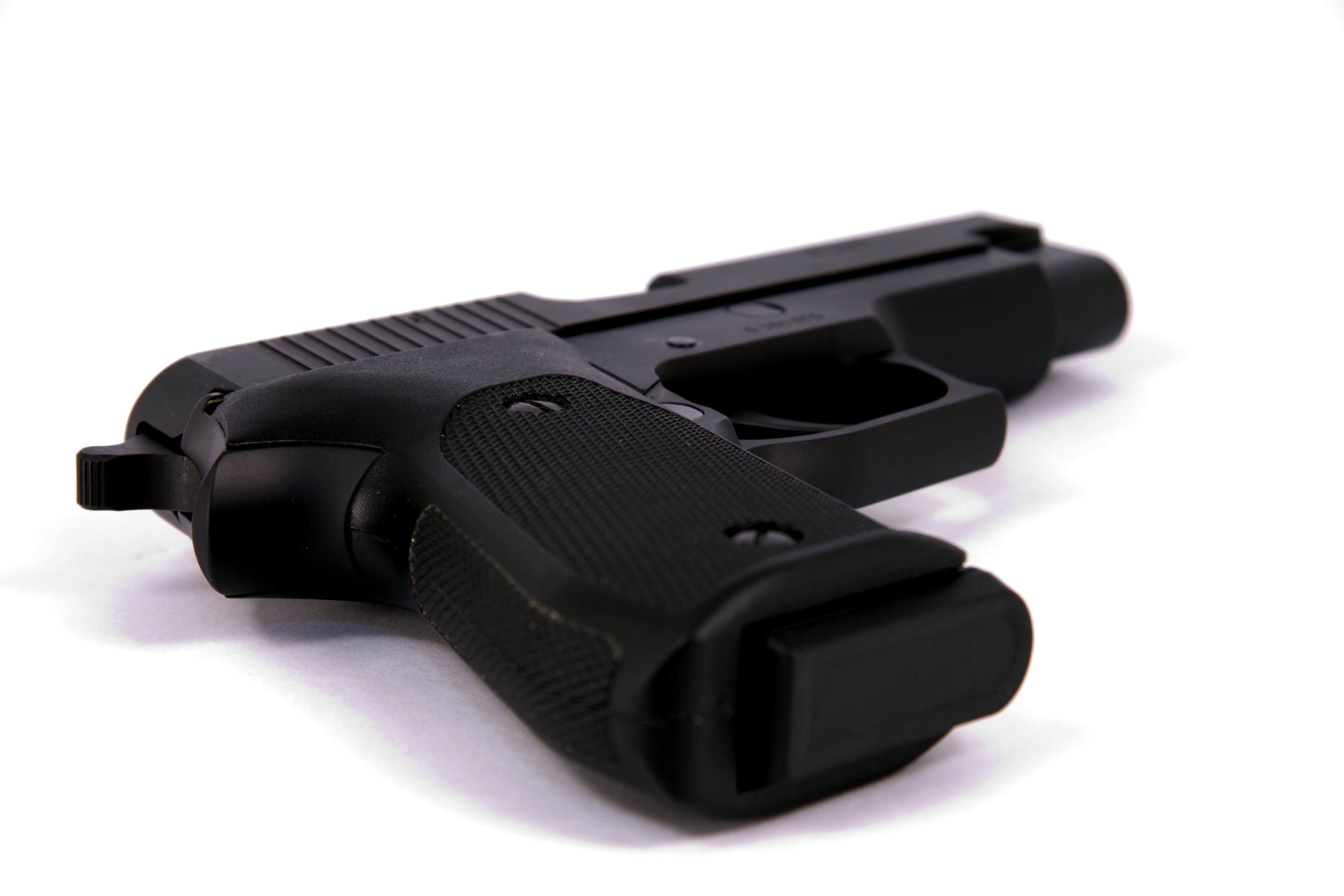 black handgun on white surface