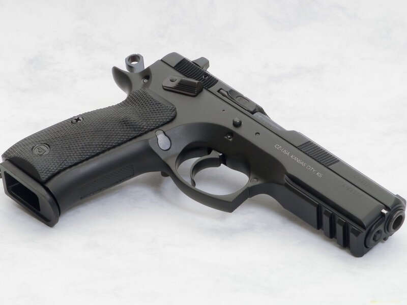 black handgun on white surface