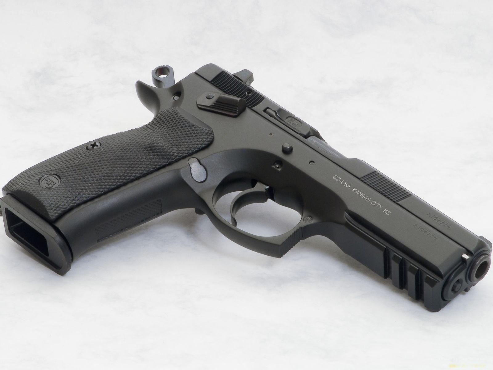 black handgun on white surface